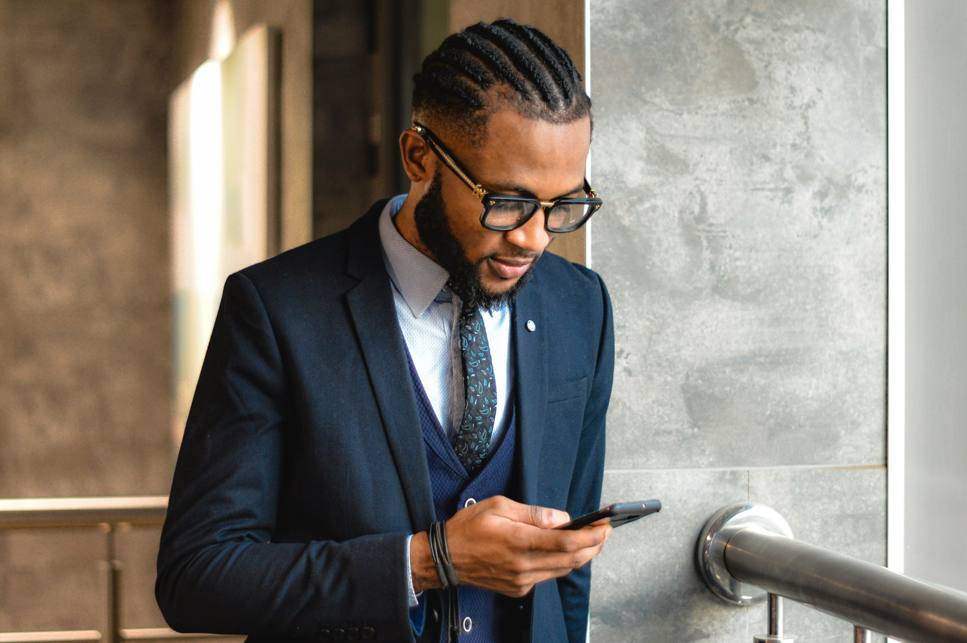 Man in glasses looking at his phone